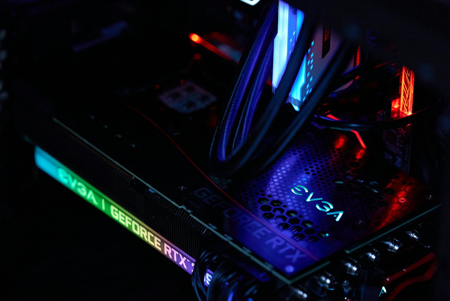 Internal computer components with colorful illuminated circuitry.